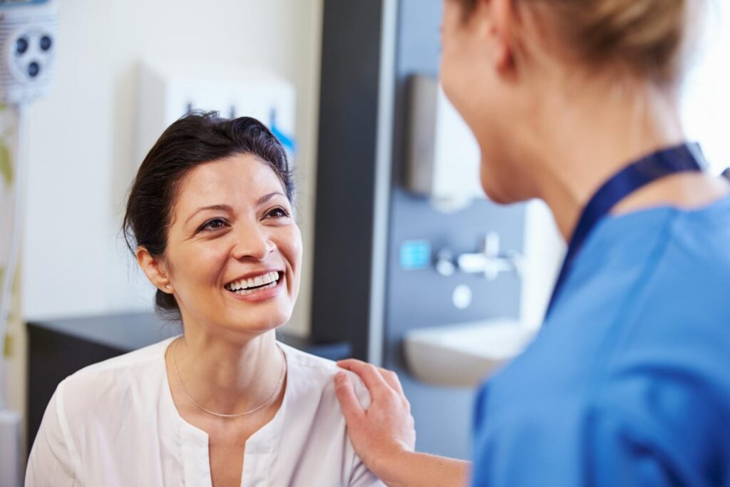 Female patient being reassured by a dentist