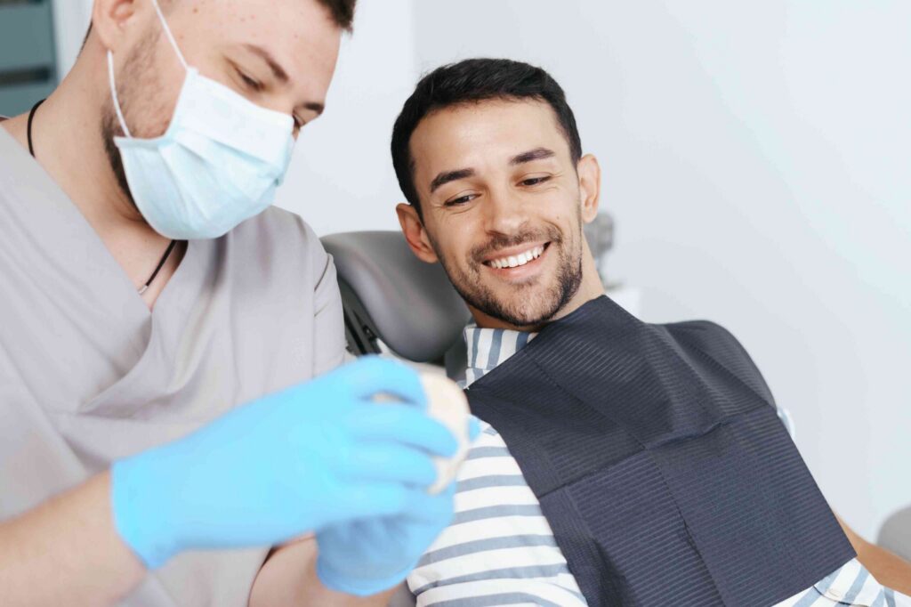 Smiling patient discussing dental implants.