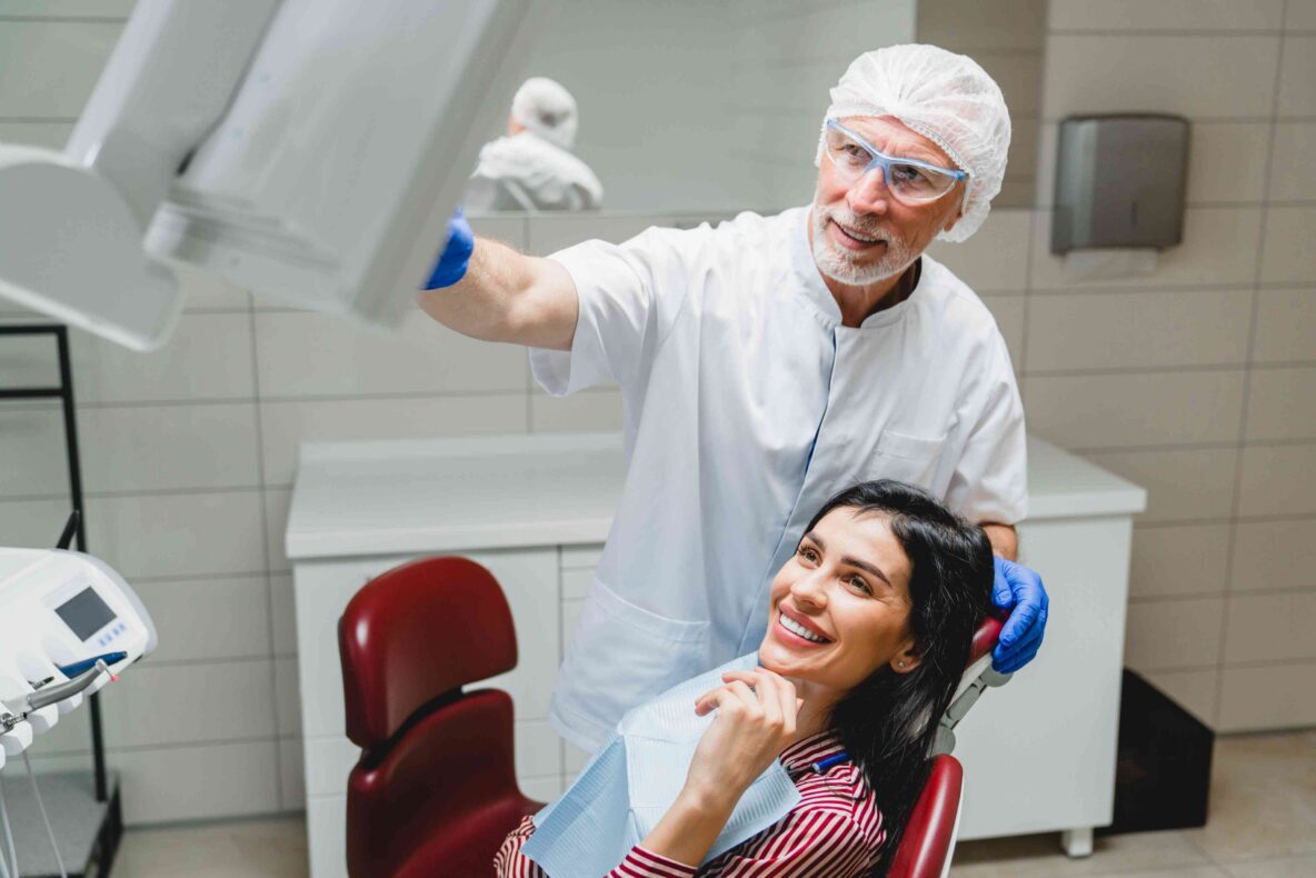 Dentist discussing treatment with a smiling patient.