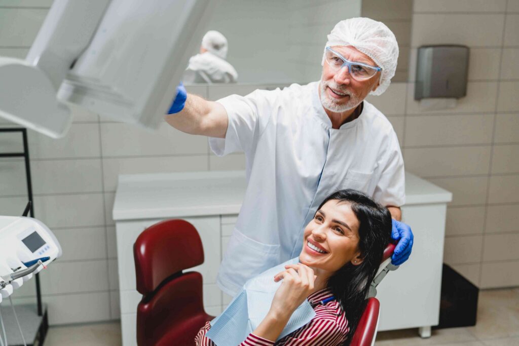 Dentist discussing treatment with a smiling patient.