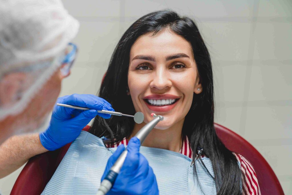 Patient smiling during a dental examination.